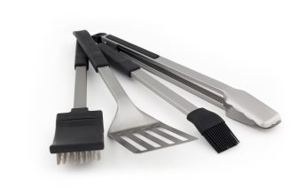 Set of stainless steel kitchen utensils with black handles (spatula, slotted spatula, tongs, brush, and scraper).